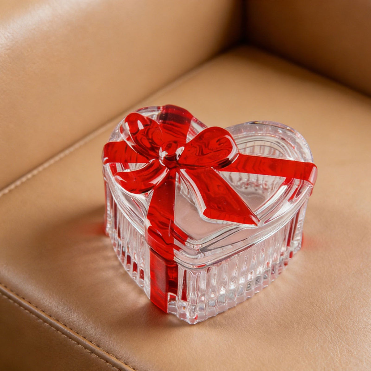 Clear glass heart-shaped candy jar with lid, red bow, ideal for snacks, jewelry, or storage, by Everything Baby.