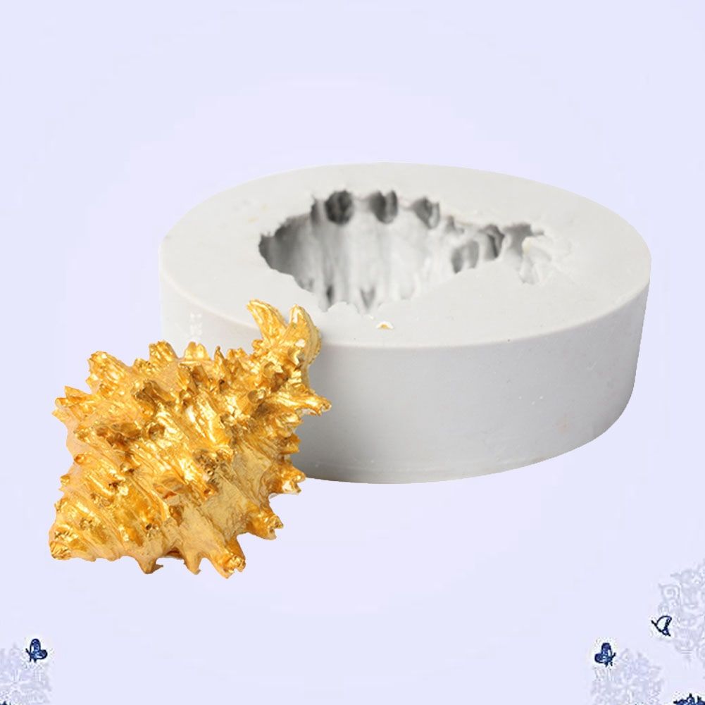 Silicone cake mold featuring conch, starfish, shell, and fishtail designs from the Marine Series by Everything Baby.