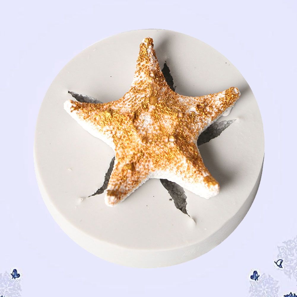 Silicone cake mold featuring conch, starfish, shell, and fishtail designs from the Marine Series by Everything Baby.