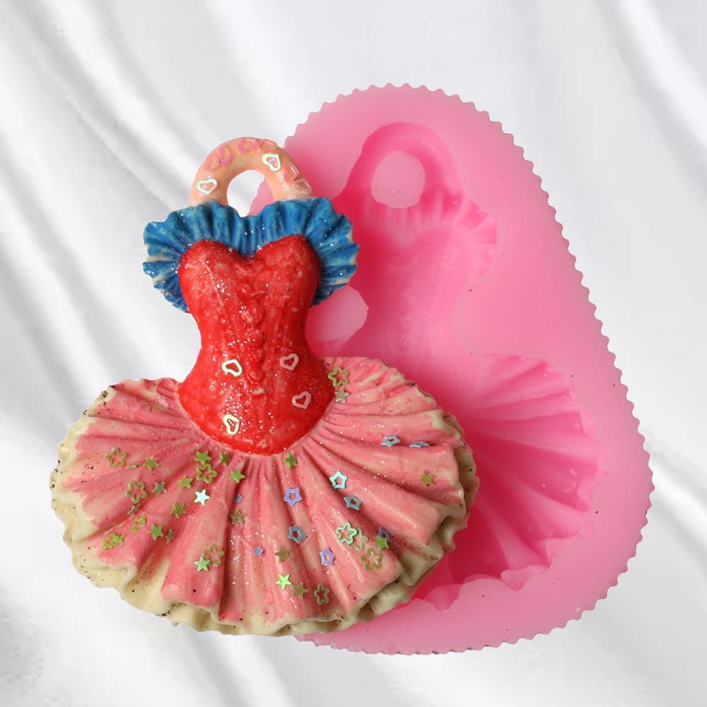 Silicone mold shaped like a baby dress for cake decorating, used for baking and sugar paste in pretend play and food crafting.