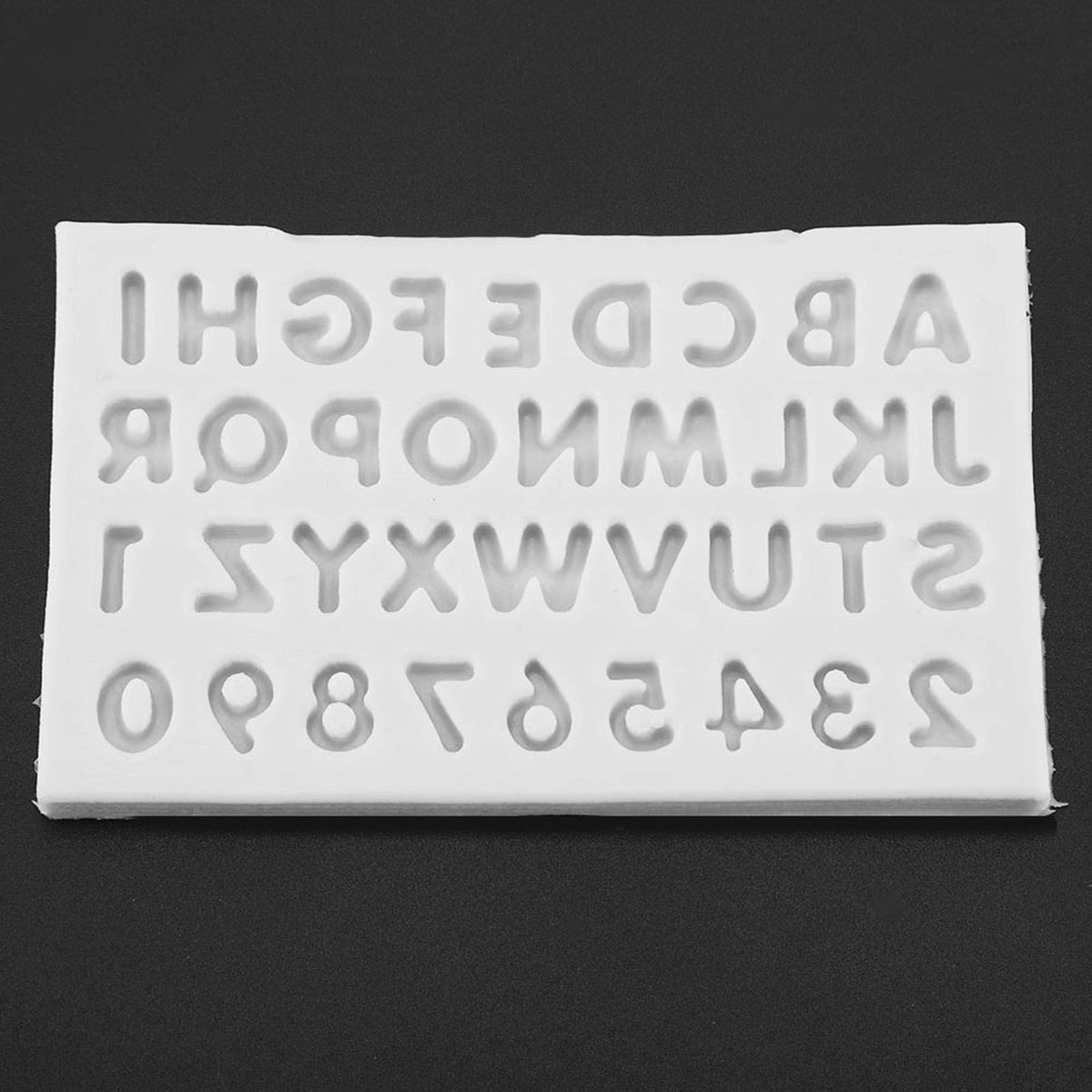 Gray silicone mold with letter shapes for cake decorating and fondant, ideal for baby and kids themed baking and feeding projects.