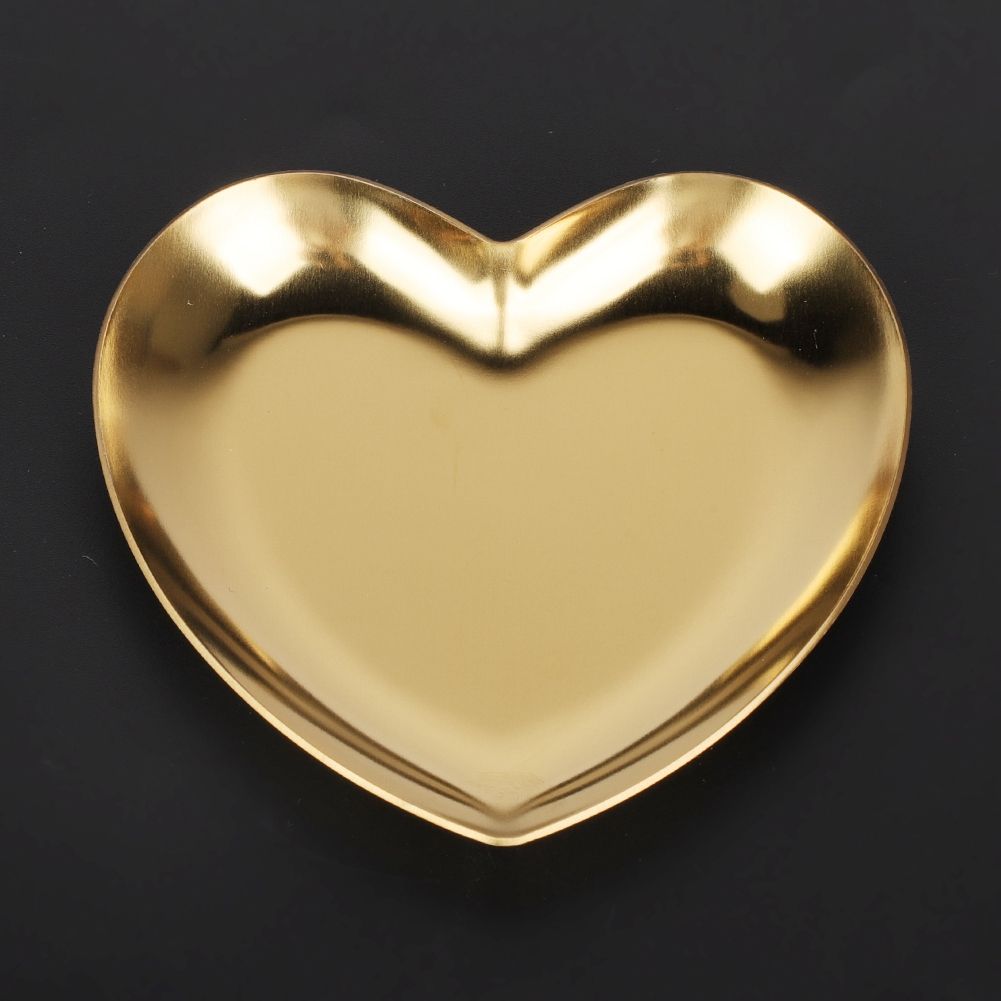 Gold stainless steel heart-shaped tray used as a tea tray, fruit tray, or jewelry organizer, ideal for home or nursery decor.