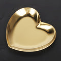 Gold stainless steel heart-shaped tray with compartments, used as a tea tray, fruit tray, or jewelry organizer, suitable for nursery use.