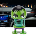 Cartoon doll head wobble toy ornament for kids' ride-on cars, featuring a playful robot design for car decoration.