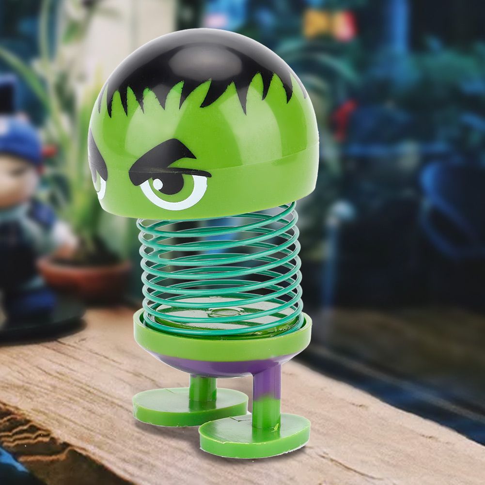 Shaking head toy ornament featuring a cartoon doll head with a wobble mechanism, suitable for car decoration or playful displays.