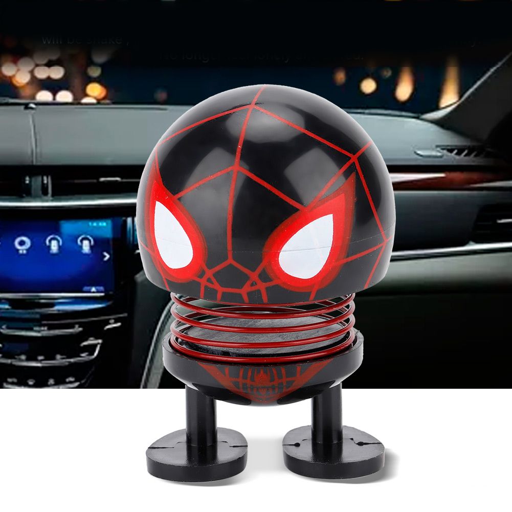 Baby ride-on car with cartoon doll head ornament featuring a wobble head design for kids' play and decoration.