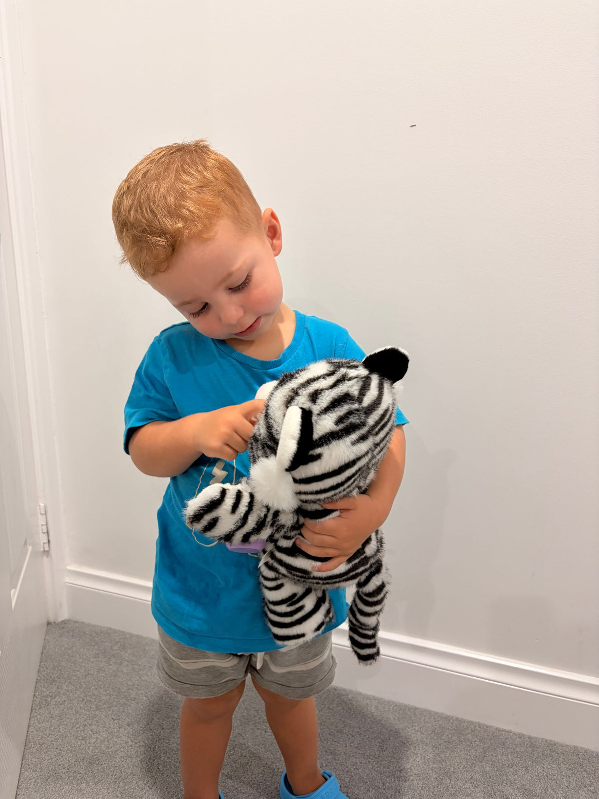 Soft plush interactive tiger toy by Everything Baby, features feeding and sleeping simulation for baby and kid play.