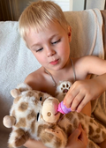 Soft plush interactive giraffe toy by Everything Baby, featuring feeding and sleeping simulation functions for babies and kids.