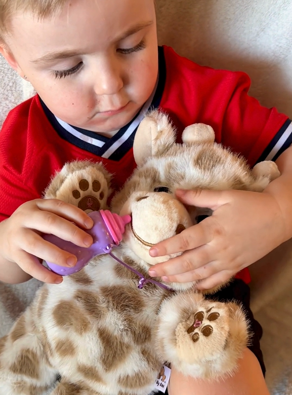 Soft plush interactive giraffe toy for babies and kids, features feeding and sleeping simulation functions, by Everything Baby.
