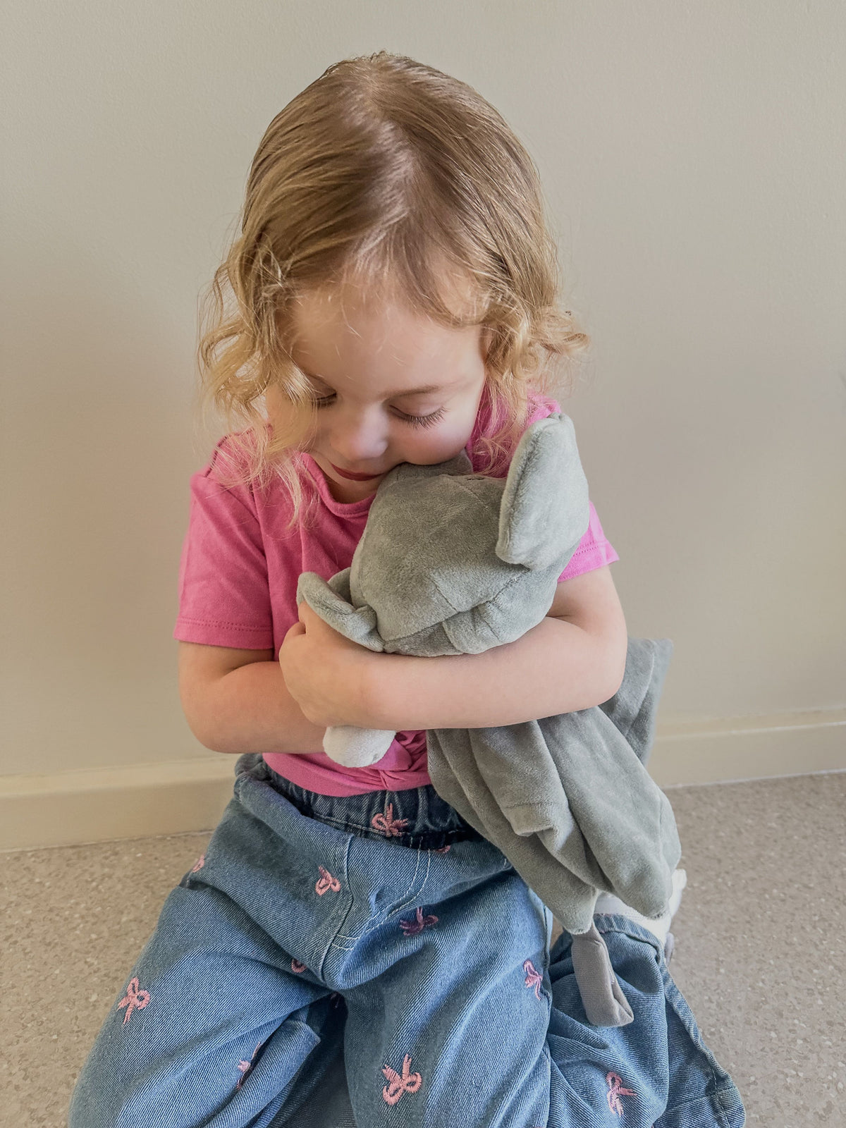 White noise and lullaby Ellie the Elephant plush comforter for babies, featuring soft fabric and musical toy functionality.
