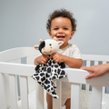 Lylah the Cow baby musical toy from Everything Baby, white noise and lullaby comforter with soft fabric and embroidered details.