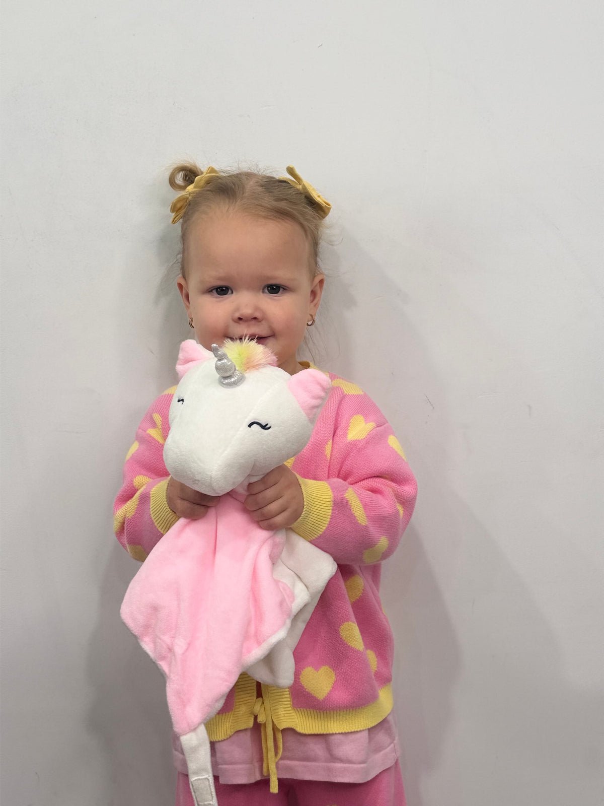 White plush unicorn comforter named Maisie by Everything Baby, designed for babies and kids, features a soothing lullaby function.