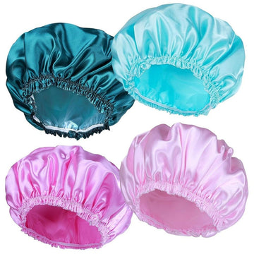 Set of four waterproof women’s shower caps in peacock green, sky blue, pink, and light pink with elastic bands for long hair and braids.