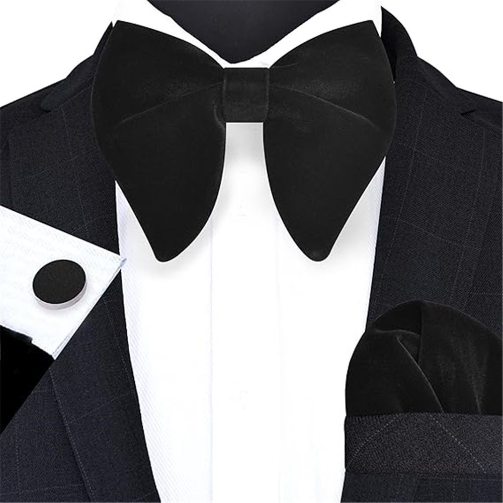 Black velvet oversized bow tie, cufflinks, and pocket square set for boys' tuxedo, styled for formal baby and kids' wear.