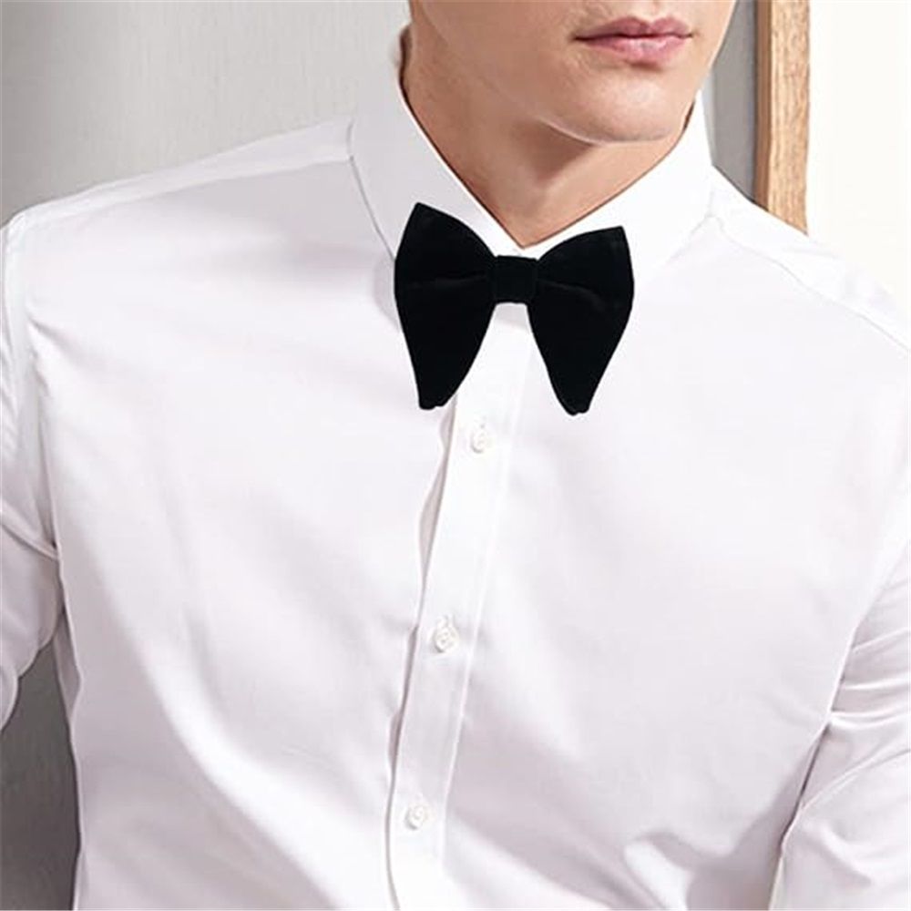Black men's velvet pre-tied tuxedo bow tie and cufflinks set with pocket square, perfect for formal occasions.