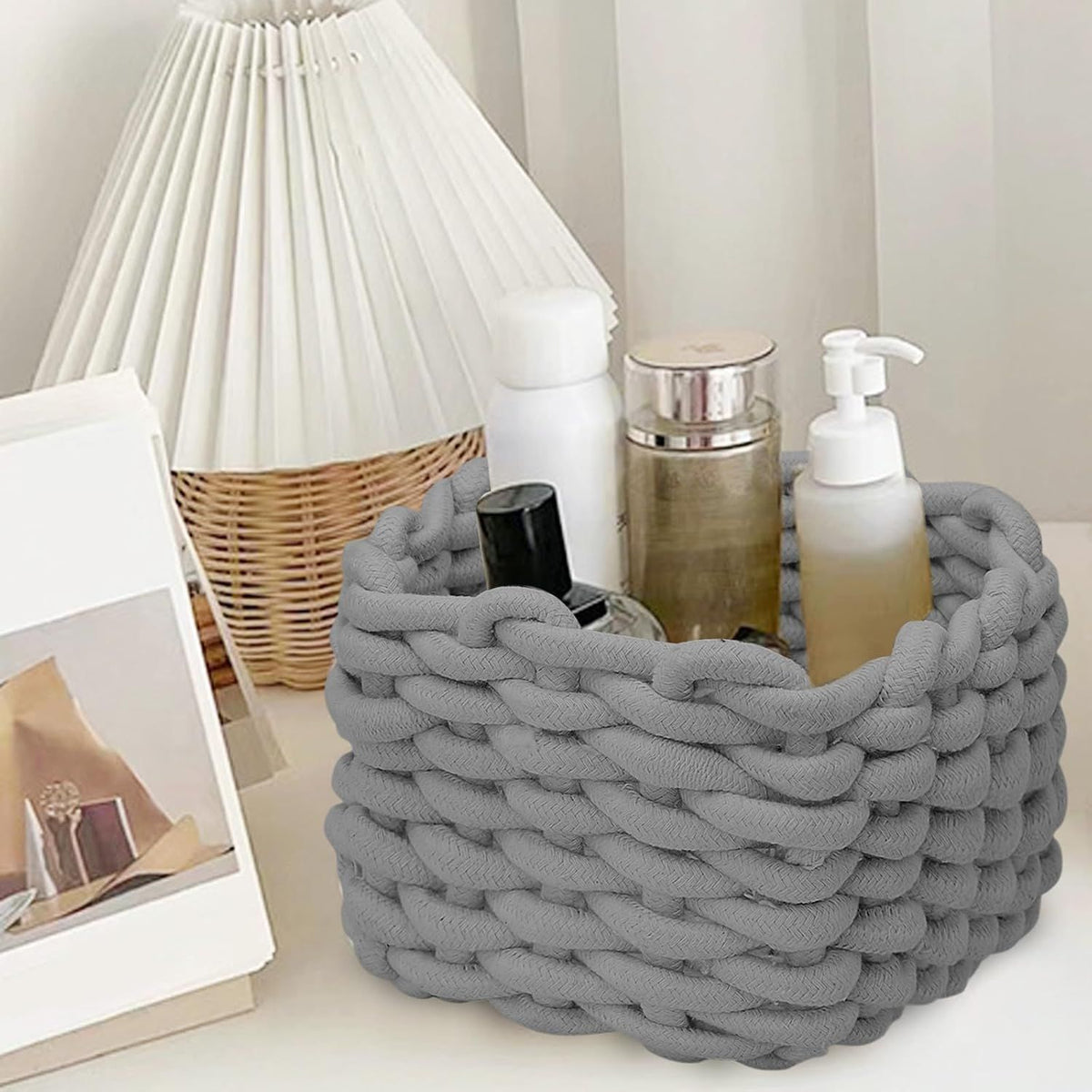 Small grey cotton rope woven storage basket for baby and kids' rooms, ideal for organizing toys and small items.