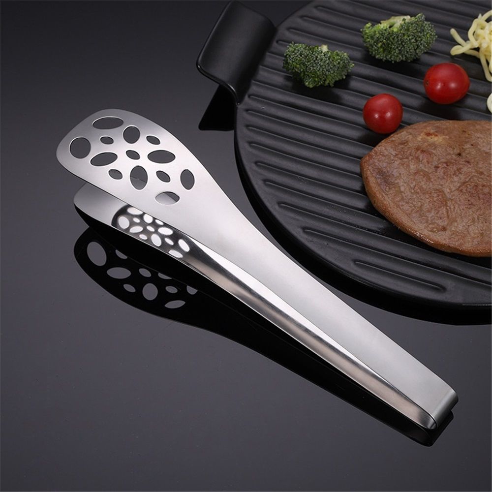 Silver 25 cm perforated serving tong with long handle, lightweight and comfortable, ideal for home parties and outdoor use.