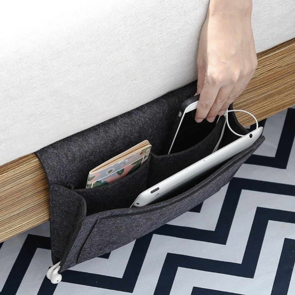 Dark gray bedside organizer for dorm room or bunk bed, holds remotes, books, tissues, and magazines, compact storage bag.