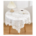 White handmade crochet lace square table runner with embroidered details, designed for round coffee tables, decorative and elegant.
