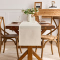 Beige linen cotton tablecloth with Independence Day, Halloween, Christmas, and Thanksgiving designs on a dining table.