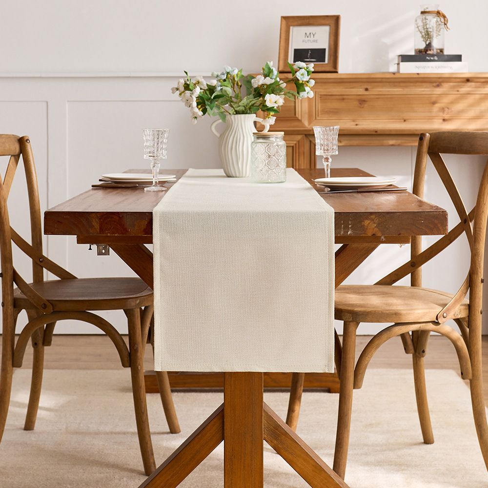 Beige linen cotton tablecloth with Independence Day, Halloween, Christmas, and Thanksgiving designs on a dining table.