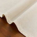 Beige linen cotton tablecloth with festive Independence Day, Halloween, Christmas, and Thanksgiving designs on a dining table.