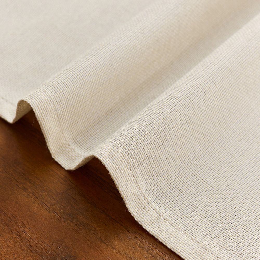 Beige linen cotton tablecloth with festive Independence Day, Halloween, Christmas, and Thanksgiving designs on a dining table.