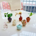 Set of 8 mini ceramic fridge magnets shaped as tiny plant vases, colorful and decorative for kitchen and office refrigerator decoration.