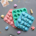 Three ocean-themed seashell silicone molds for chocolate, candy, and fondant cake decorating by Everything Baby.
