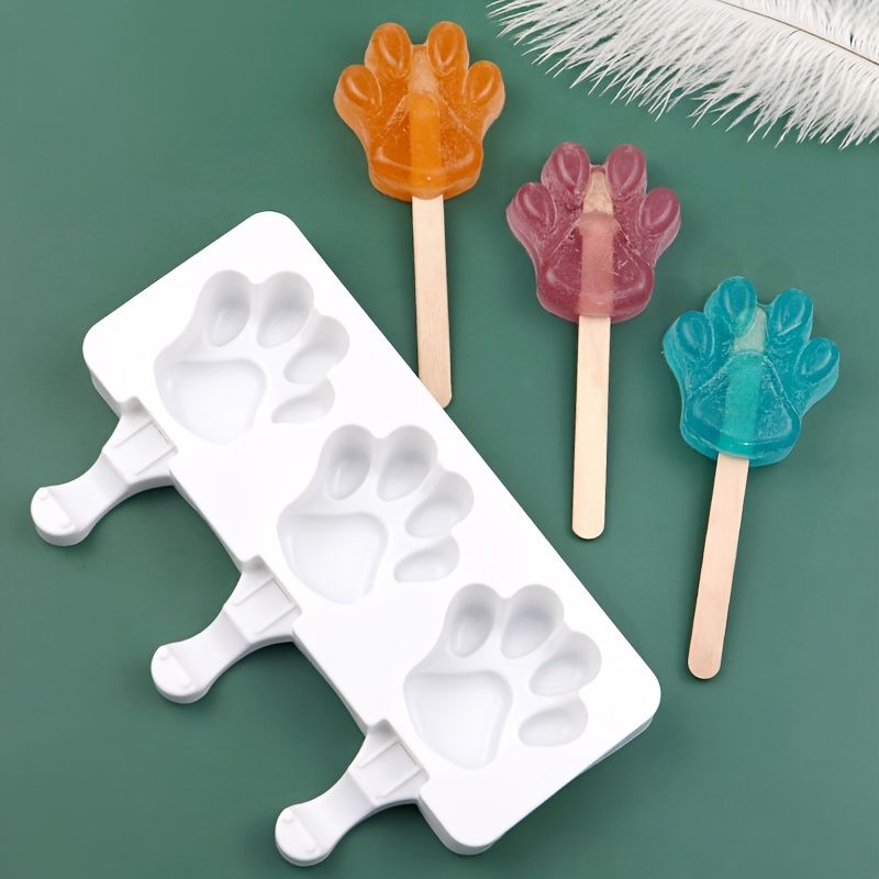 White silicone 2-piece cat paw popsicle mold for DIY ice cream treats, ideal for summer fun and pretend play with kids.