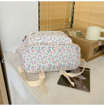 Blue floral aesthetic backpack for kids with cute spring and summer flower design, casual daypack for children.