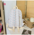Blue floral backpack for kids with cute spring and summer design, featuring colorful flower patterns on a casual daypack style.