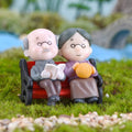 Miniature garden park bench ornament featuring Grandpa and Grandma figures, ideal for outdoor landscape decor and kids' play areas