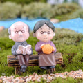 Miniature garden park bench ornament with grandpa and grandma figures, outdoor landscape decor, by Everything Baby.