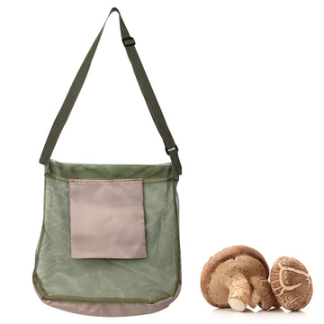 Green mushroom foraging bag from Everything Baby with a cute mushroom design, ideal for collecting wild mushrooms.