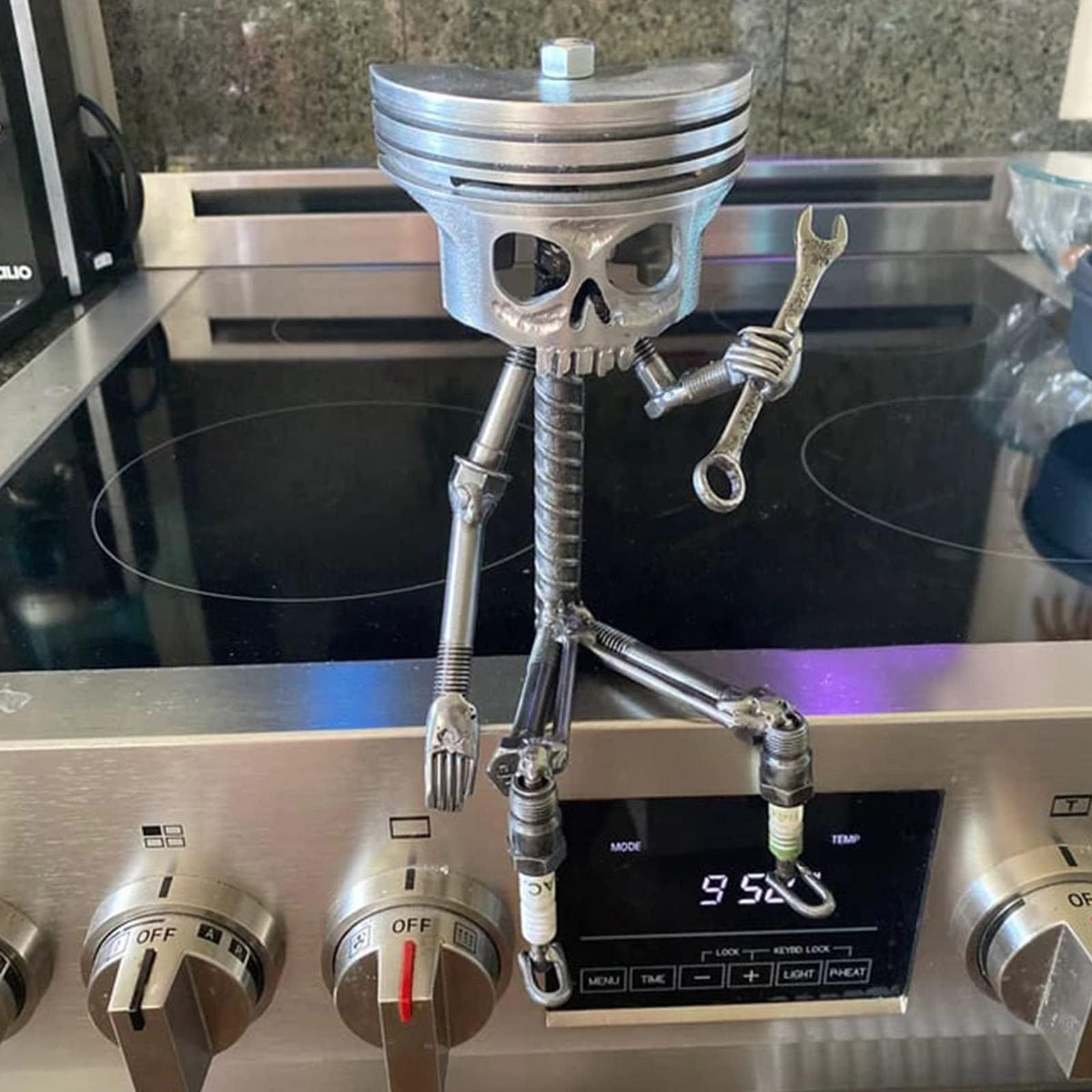 Handmade metal piston skull face sculpture with carved skeleton design, suitable as a unique art figurine for display or collection.