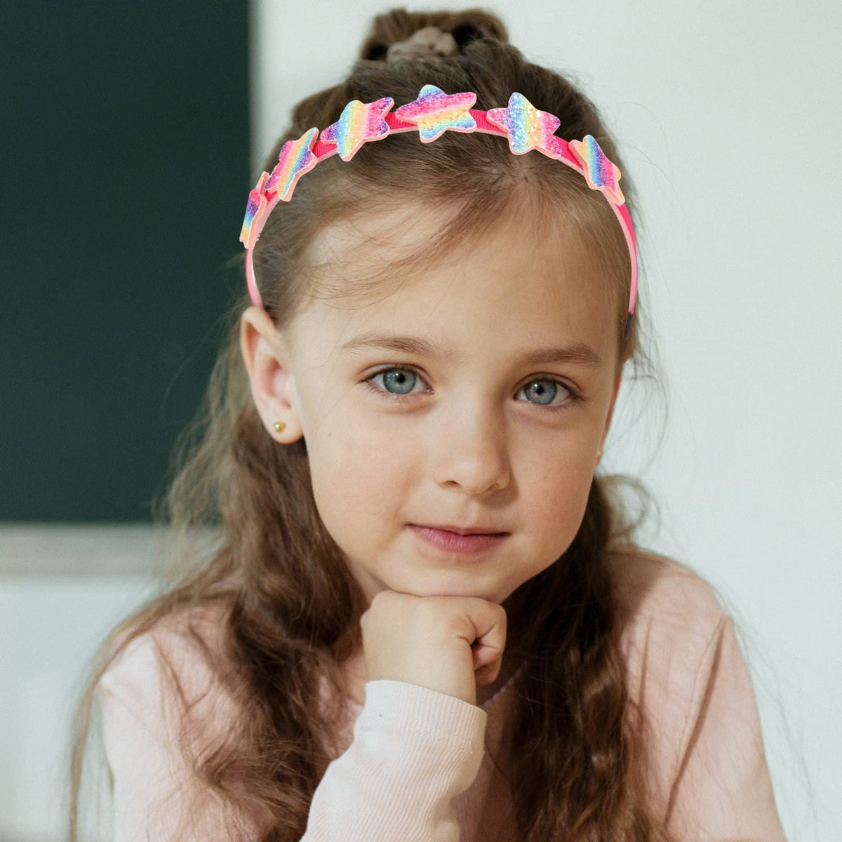 Six colorful rainbow glitter headbands with sparkling star accents for baby girls, featuring decorative and playful designs by Everything Baby.