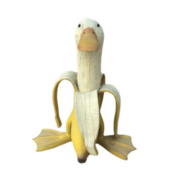 Whimsical duck sculpture with a peeled banana body, decorative garden yard art, suitable for outdoor or indoor play spaces.