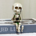 White 4.5-inch resin mini skeleton figurine for Halloween decor and haunted house craft accessories.