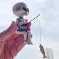 White 4.5-inch resin mini skeleton figurine for Halloween home decor, perfect as a spooky accessory or toy for haunted house setups.