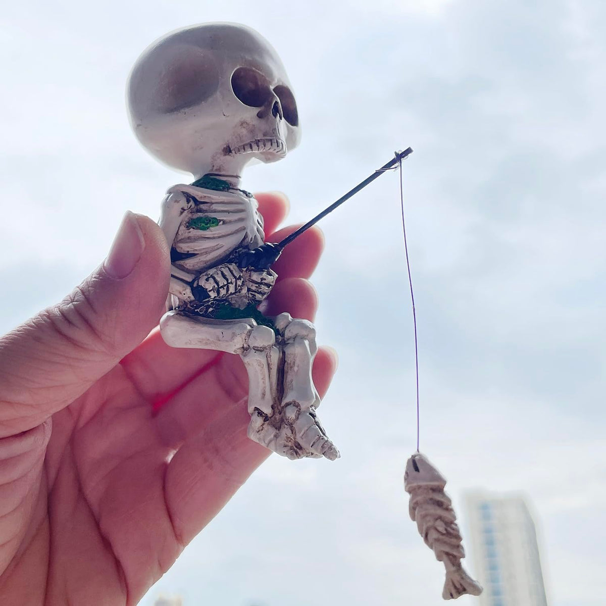 White 4.5-inch resin mini skeleton figurine for Halloween home decor, perfect as a spooky accessory or toy for haunted house setups.