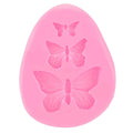Pink butterfly fondant mold for cake decorating, gummy candy, and chocolate shaping, suitable for baking and polymer clay crafts.