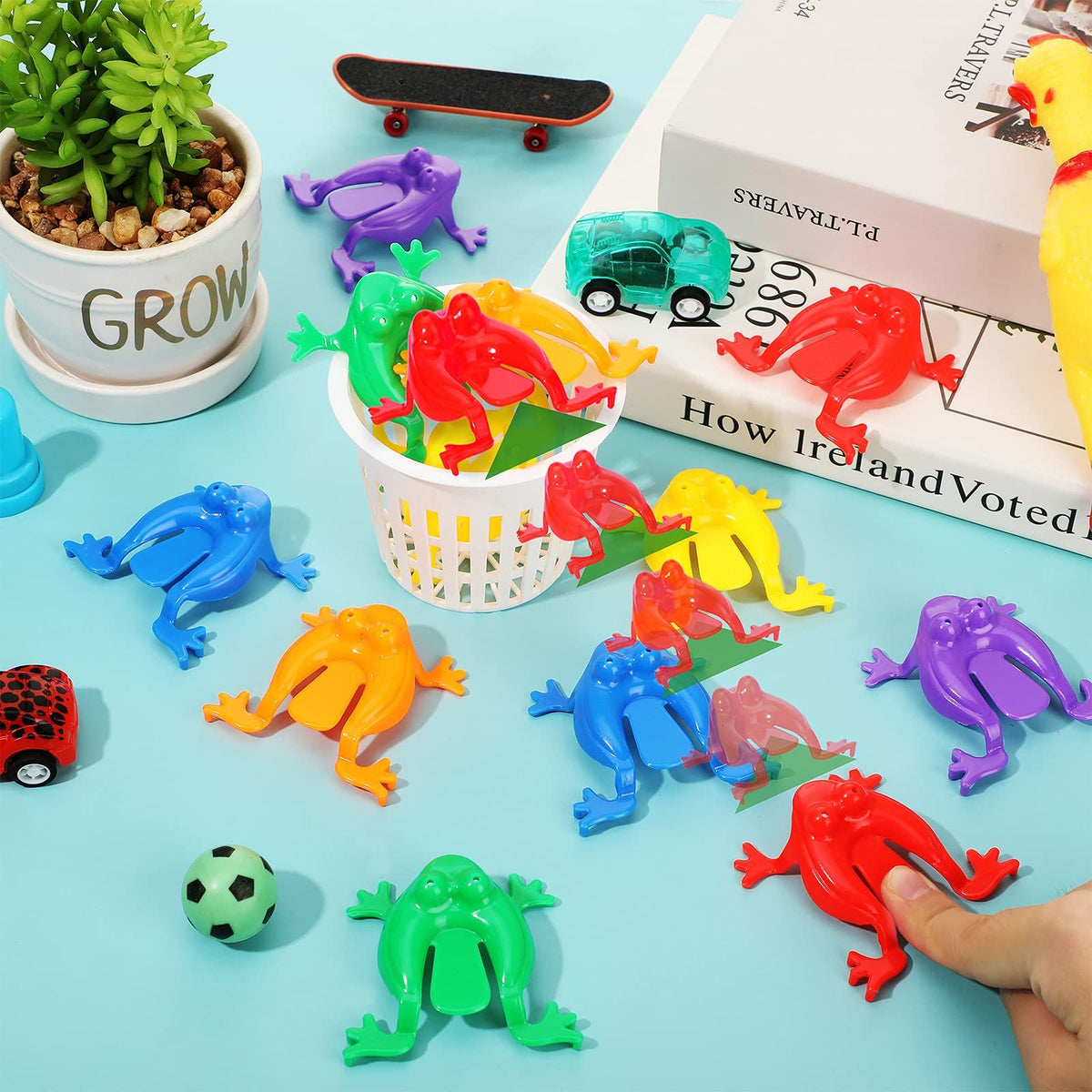 Set of 12 colorful plastic frog toys, 2 inches tall, for pretend play and kids' activities, featuring jumping frogs in assorted colors.