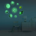 Set of 9 glow-in-the-dark planet wall stickers featuring Sun, Earth, and other planets, ideal for kids' room decor.