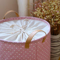 Foldable cotton and linen dirty clothes and toy storage basket from Everything Baby, featuring a soft, collapsible design for kid’s room organization.