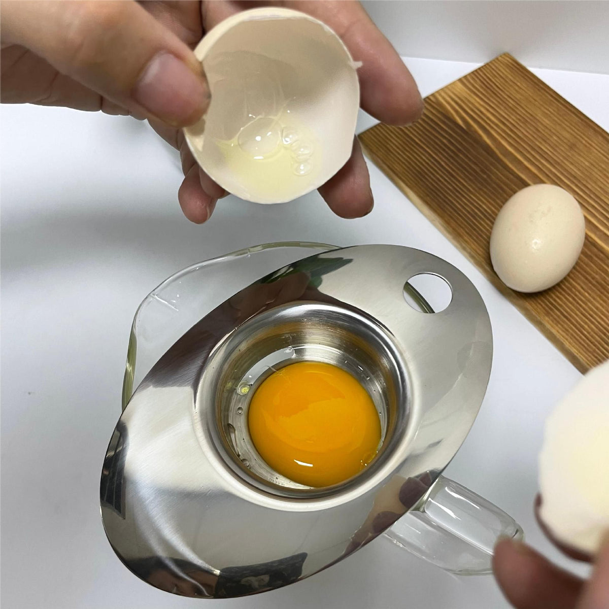 Premium stainless steel egg separator tool for baking, designed for easy separation of egg yolks and whites.