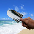 Foldable stainless steel outdoor shovel with ergonomic handle, suitable for kids' outdoor play, gardening, and digging activities.