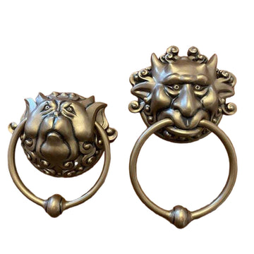 Set of two bronze door handles featuring whimsical dragon face designs, wall-mounted decorative door carvings for home decor.