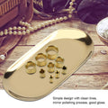 Gold oval stainless steel tray with decorative design, ideal for jewelry, perfume, or bathroom vanity display.