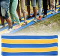 Kids and teens playing carnival team building games on a colorful run mat for fun group activities with Everything Baby.